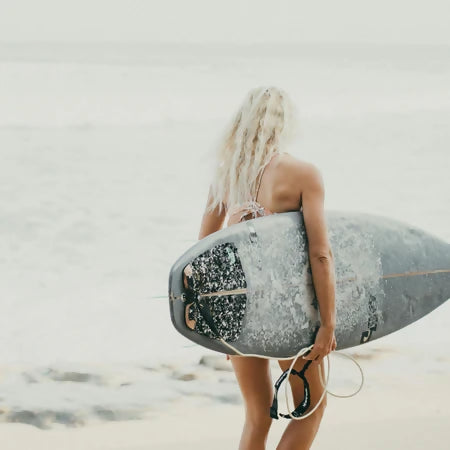 Woman at the beach representing natural sun care and outdoor skin protection