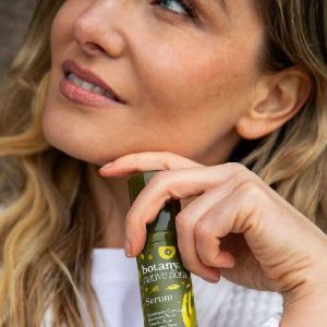 Botany Essentials Native Flora Serum held by model