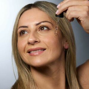 Botany Essentials DNA Serum Hydrate being applied by model
