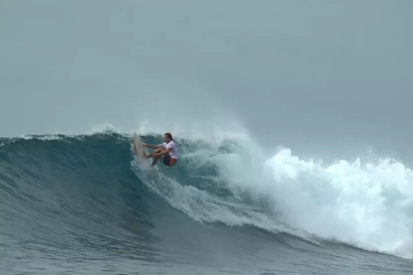 Riley foam core balsa Fish surfboard being ridden through a breaking wave