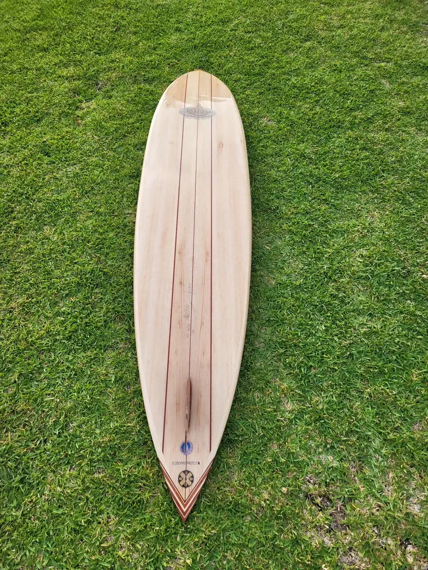 Top view of the Riley Balsawood solid balsa Hawaiian Gun surfboard on grass