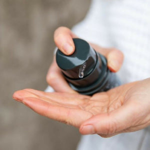 Botany Essentials Native Flora Face Cleanser being dispensed into hands