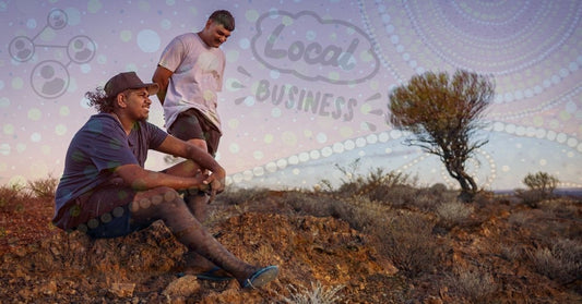 Two First Nations men sitting on Country in the Australian outback with artwork overlay and the words Local Business.