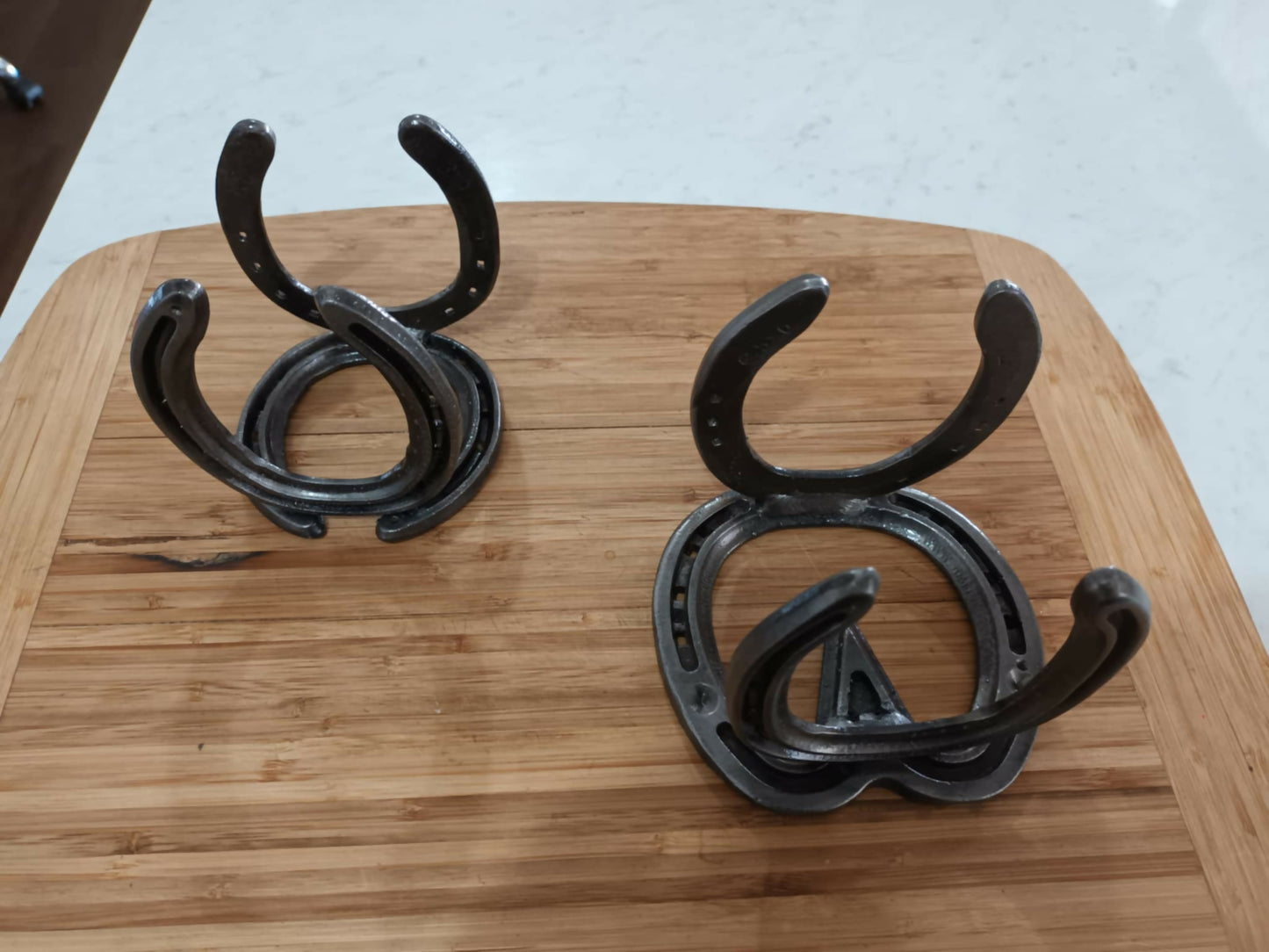 Twin set of handmade horseshoe envelope and book holders by Noah’s Creations.