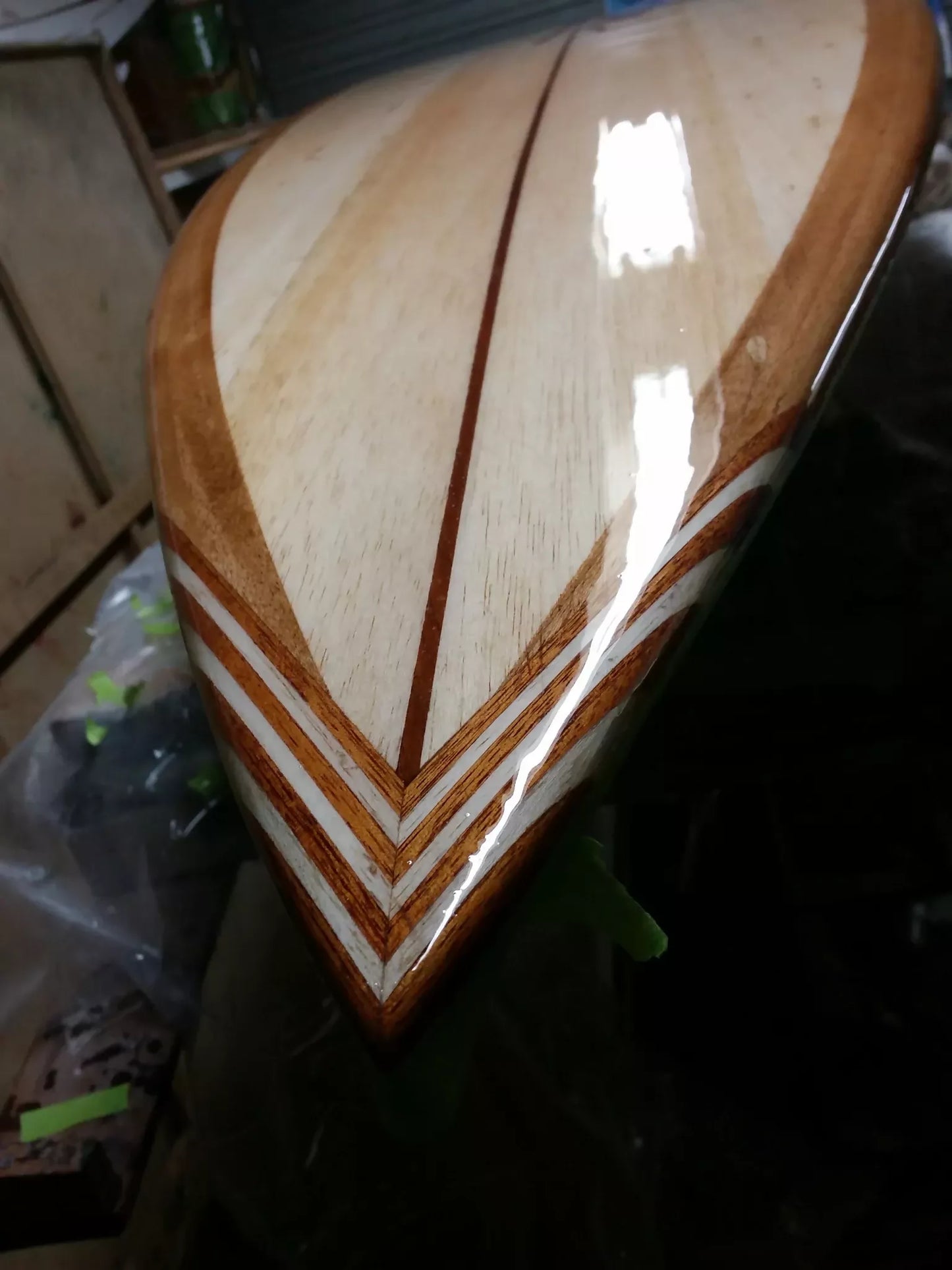 Close-up of the handcrafted timber tail inlay on a Riley Balsawood surfboard