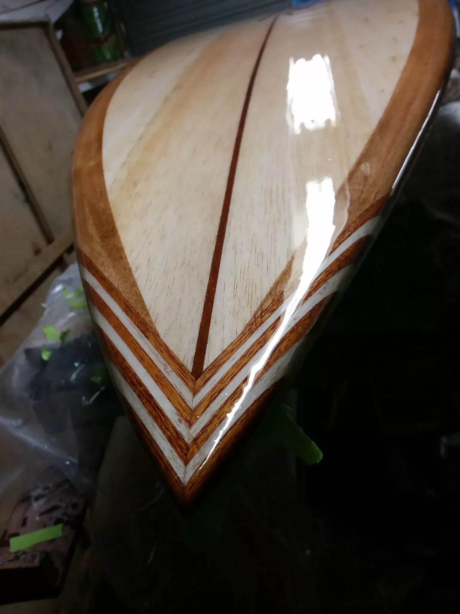 Close-up of the handcrafted timber tail inlay on a Riley Balsawood surfboard