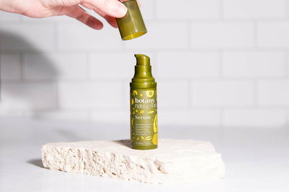 Applying Native Flora vitamin C serum skincare product with dropper applicator