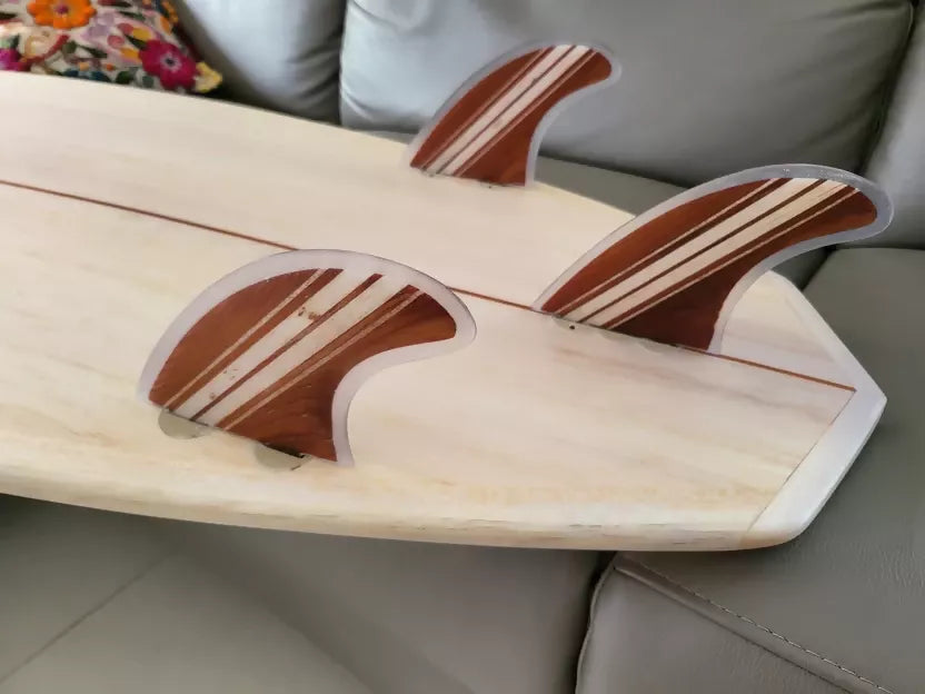 Close-up of the thruster fins on a Riley Hybrid Balsa Secret Weapon surfboard