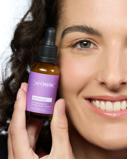 Woman holding Australian bakuchiol face serum for healthy glowing skin