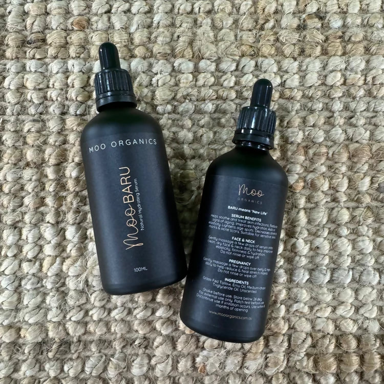 Moo Organics MOO BARU Hydrating Tallow Serum bottles on textured fabric