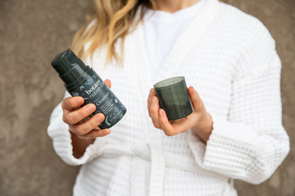 Woman holding Australian Native Flora face cleanser skincare products