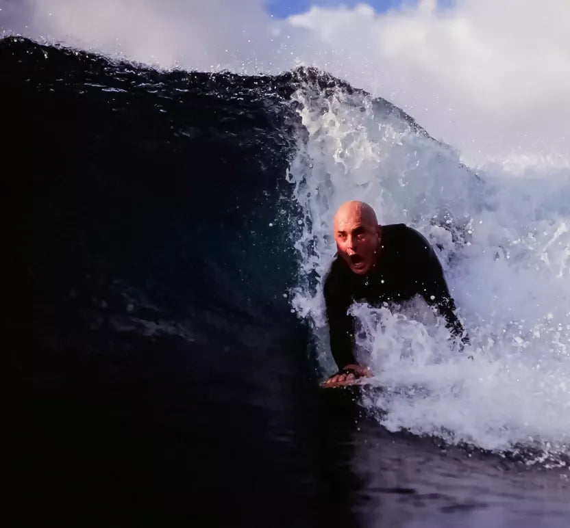 Bodysurfer riding a wave with a Riley solid balsa bodysurfing handboard