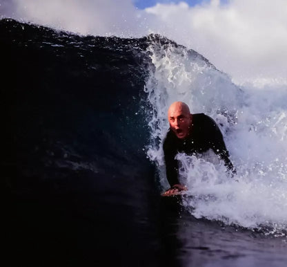 Bodysurfer riding a wave with a Riley solid balsa bodysurfing handboard