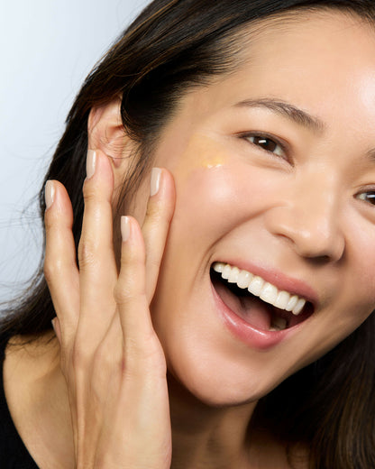 Woman with glowing skin using Australian vitamin C serum skincare product