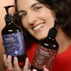 Woman holding Botany Native Flora Conditioner 500ml Australian made hair care