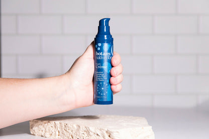 Hand holding Australian Native Flora night moisturiser skincare product