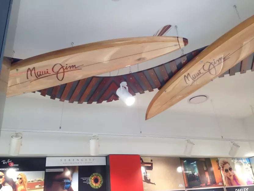 Riley Balsawood surfboards hanging from the ceiling inside the workshop