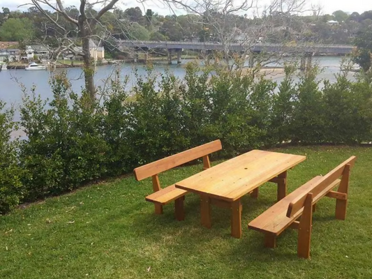 Three piece Australian hardwood outdoor picnic table set beside waterfront lawn area in Australia
