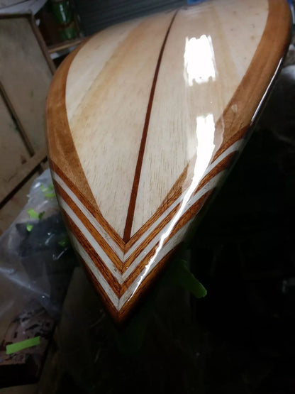 Close-up of the handcrafted timber tail on a Riley foam core balsa Hawaiian Gun surfboard