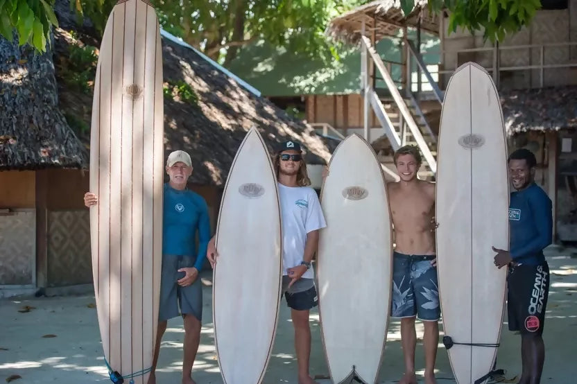 Line-up of handcrafted Riley balsa surfboards displayed outdoors