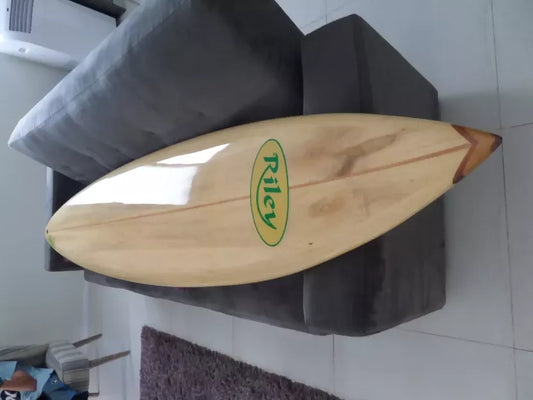 Riley Balsawood Hawaiian Gun surfboard shown from the side while being held