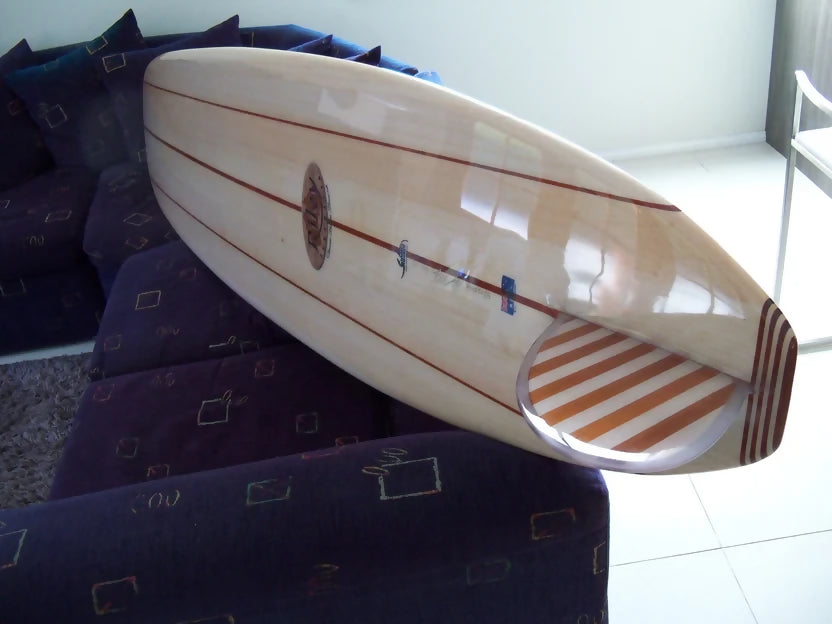 Riley Allrounder solid balsa Mini Malibu surfboard viewed from the tail in the workshop
