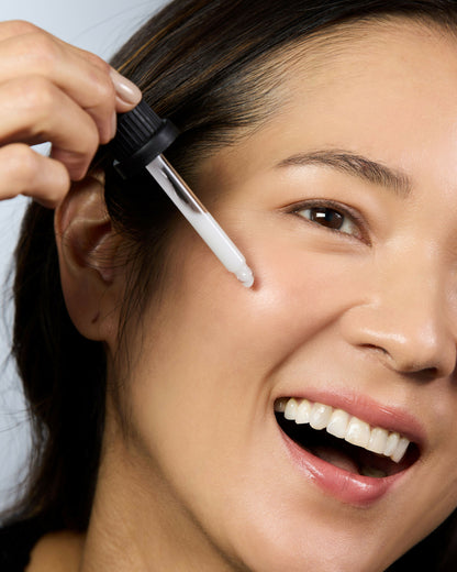Woman applying Australian niacinamide face serum for hydrated and healthy glowing skin