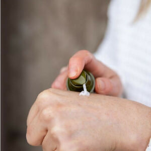 Botany Essentials Native Flora Serum being dispensed into hands
