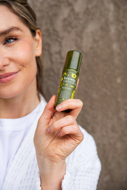 Woman using Australian Native Flora face serum for hydrated radiant skin