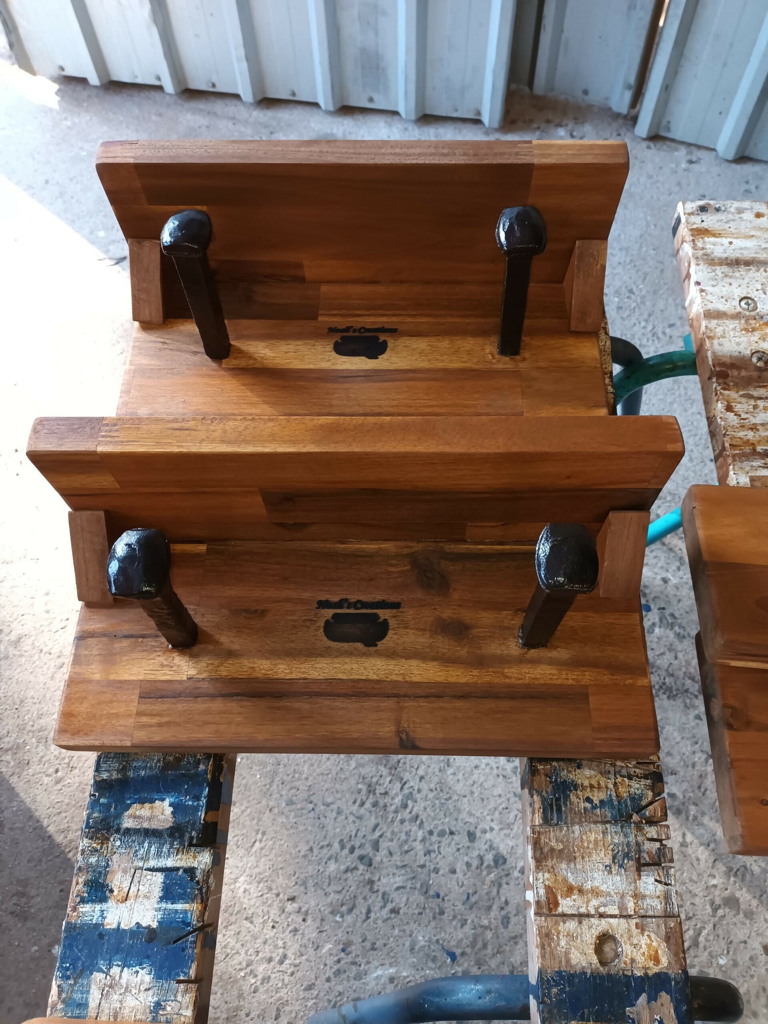 Two handmade timber hat and coat racks with railway spike hooks and shelves by Noah's Creations.
