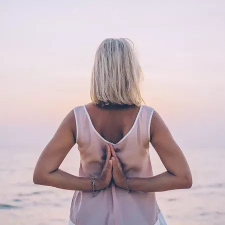 Woman relaxing outdoors representing natural skincare and wellness routine