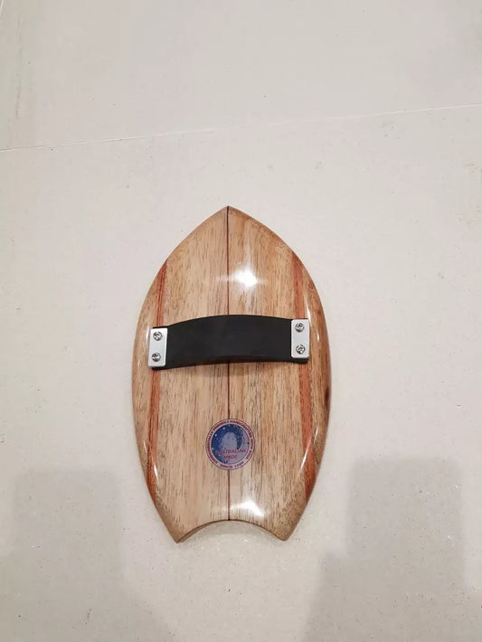 Underside of a Riley solid balsa bodysurfing handboard showing the rubber strap